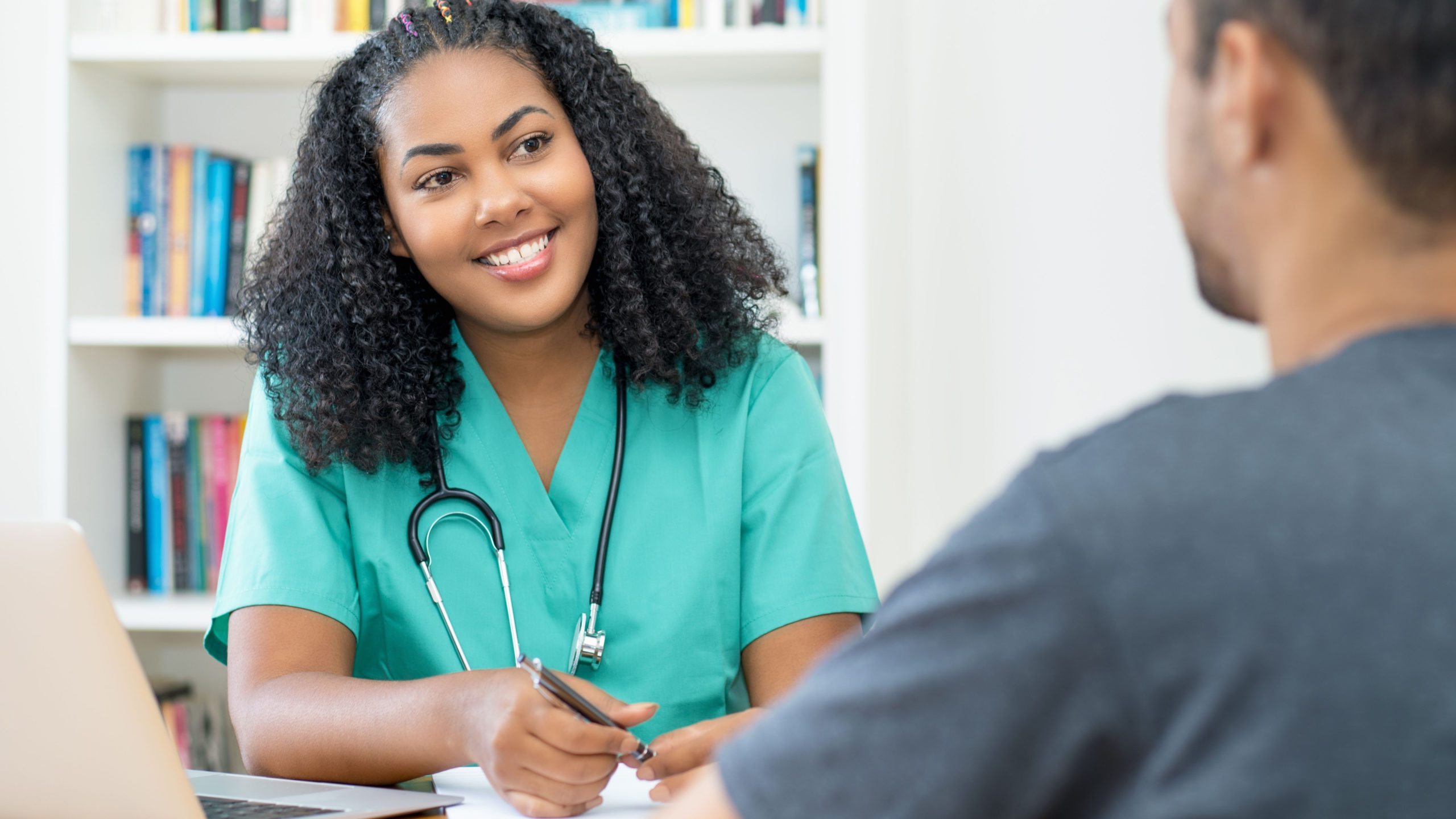 An interviewer at a residency program meeting with applicants.